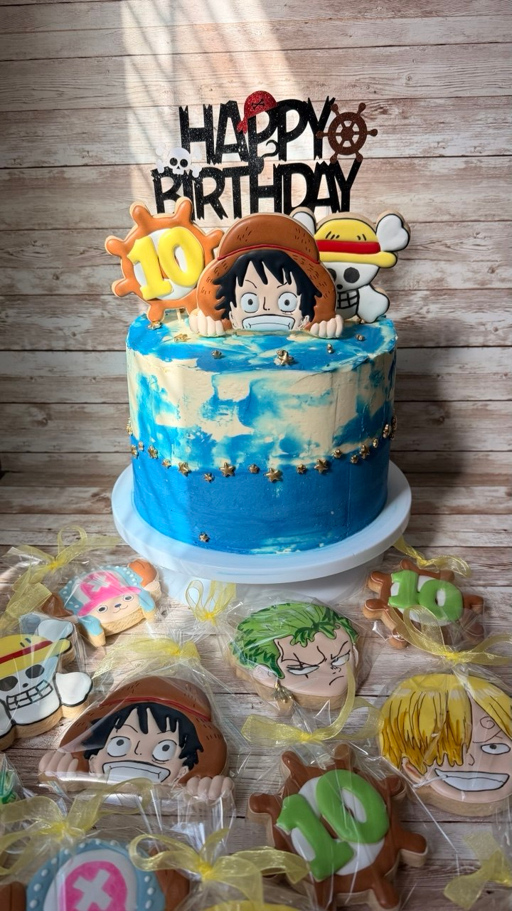 Edible character toppers on a blue birthday cake